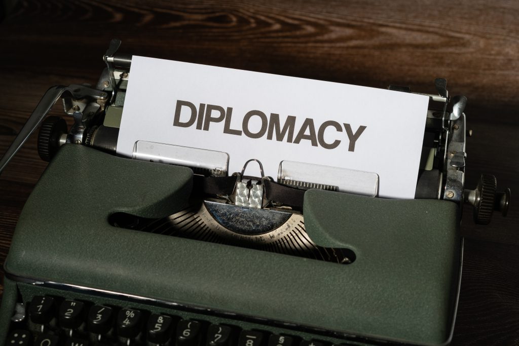typewriter with a white sheet of paper and a subtitle Diplomacy